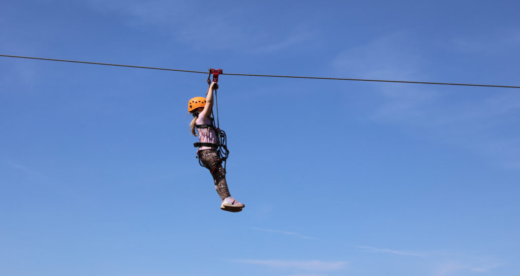 Girl ziplining at the 2025 DBAS Family Weekend.